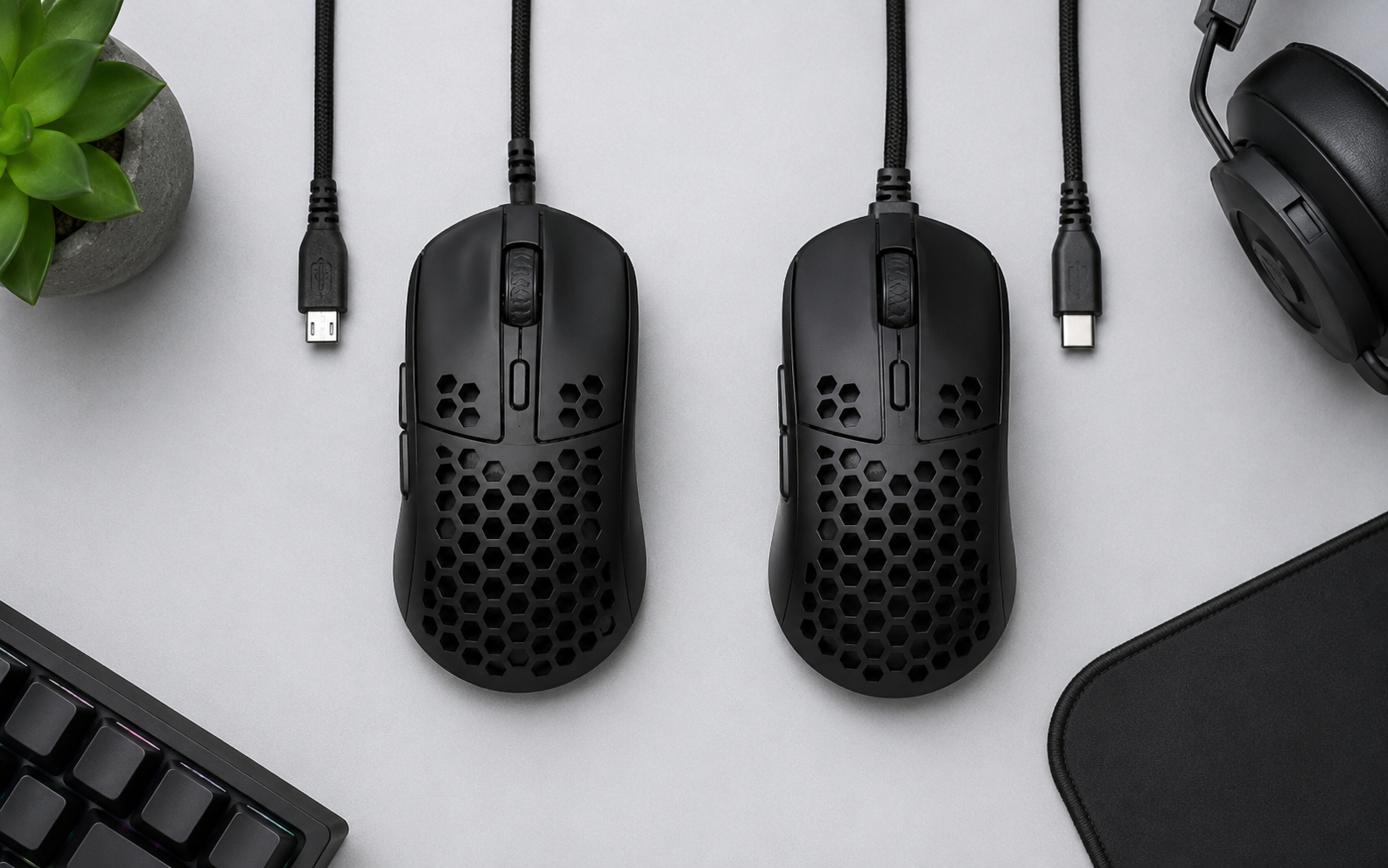 Two ultra-light gaming mice shown with older and newer charging cables
