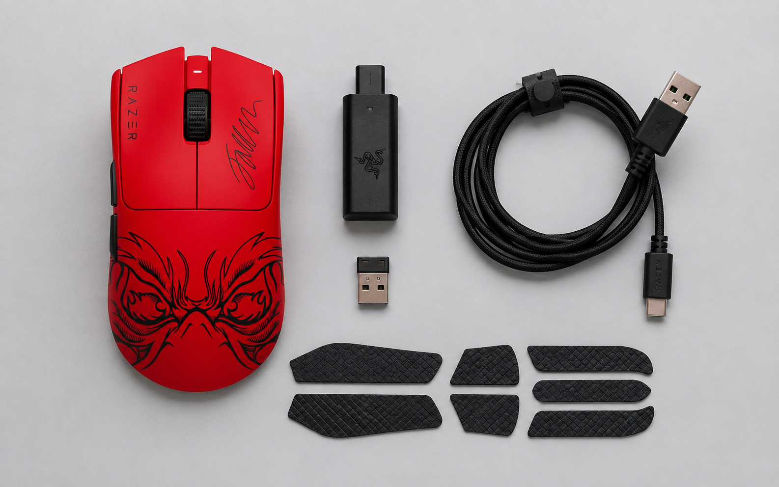 Red gaming mouse with wireless dongle, receiver, USB-C cable and grip tape