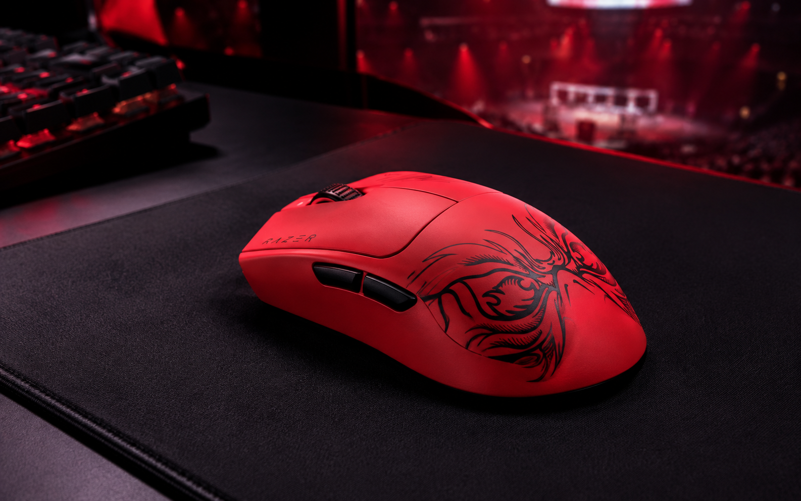 Red esports gaming mouse with black Faker Edition graphics on a gaming desk